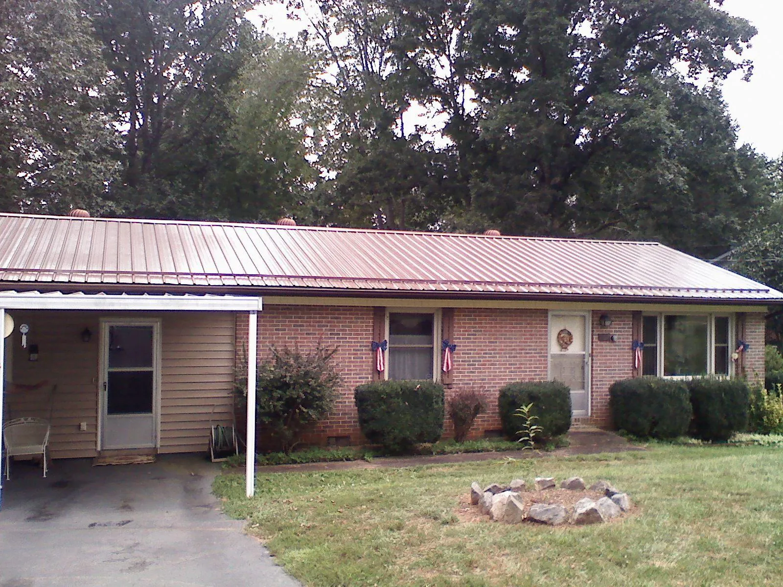 Bronze metal roof and carport on a brick ranch home — Roof Repair work by our crew in Burlingame